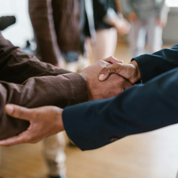 Close-up of two businesspeople shaking hands, symbolizing agreement and partnership.